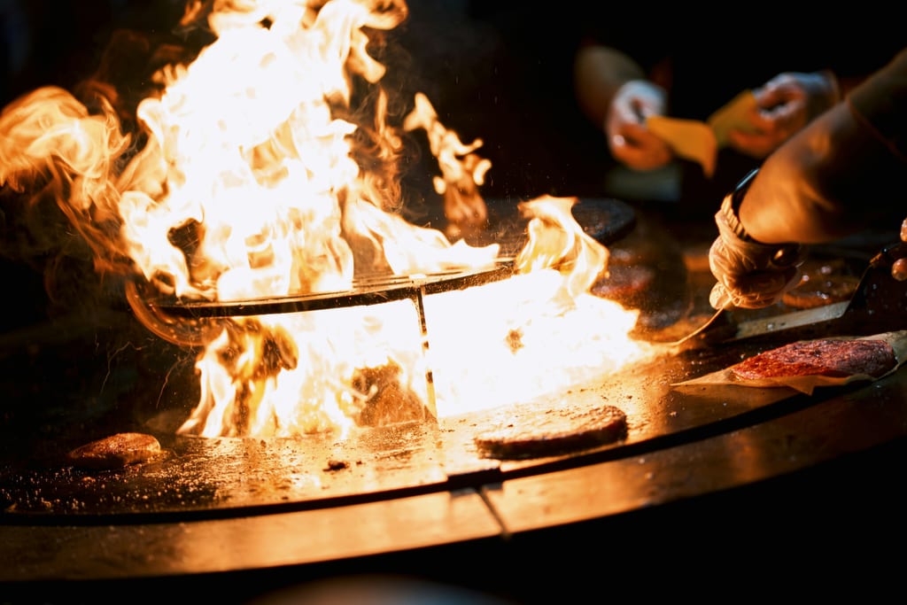 Flames rising from a grill