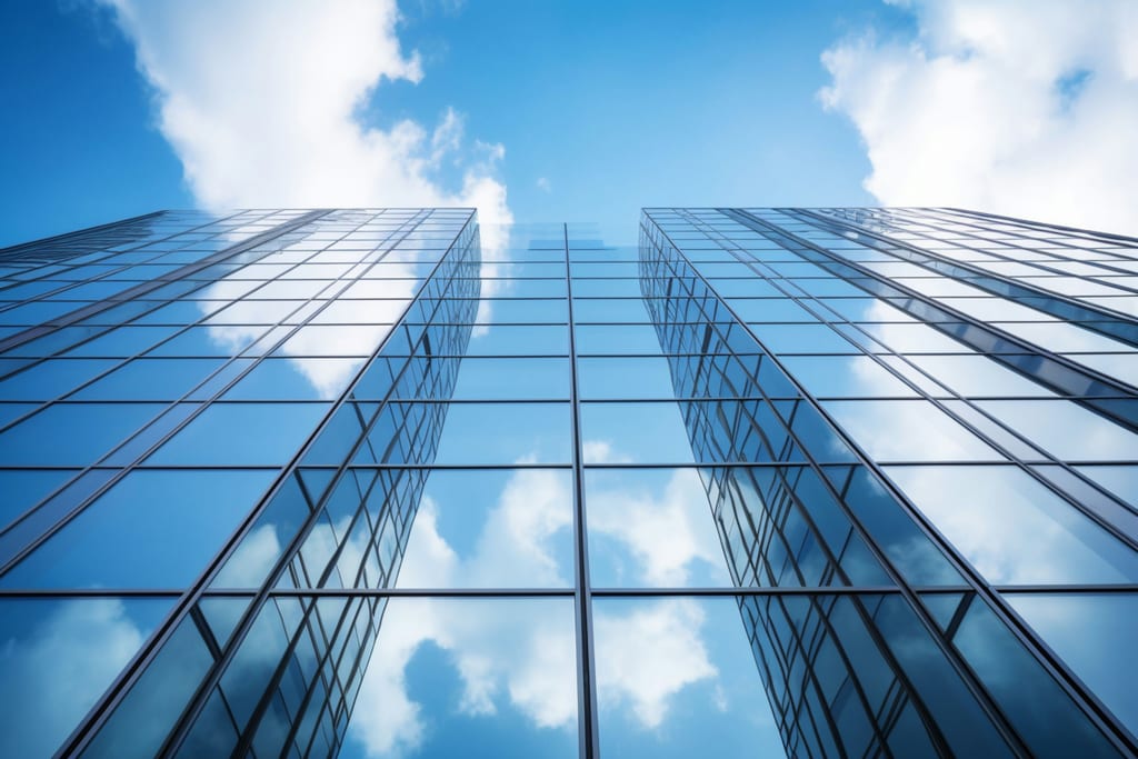 Glass office towers against a bright sky