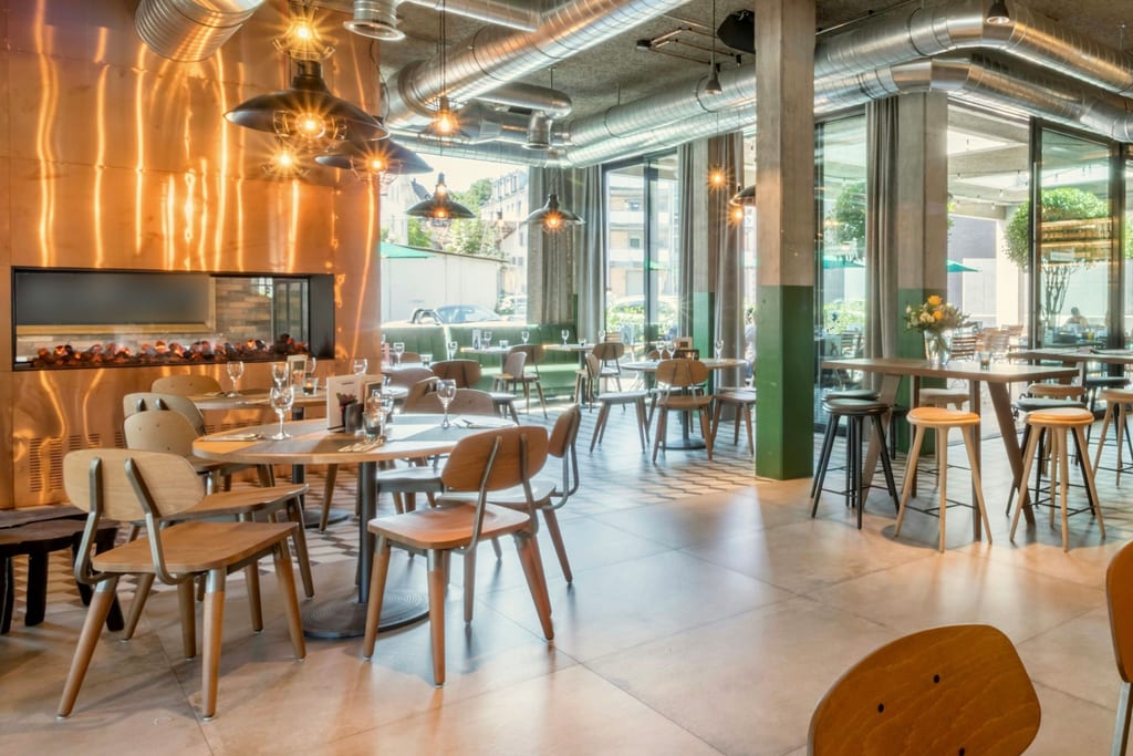 Bright restaurant with a copper wall and pendant lights